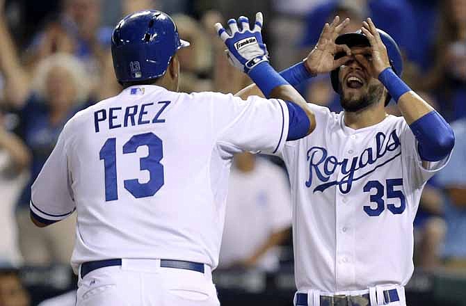 Kansas City Royals' Salvador Perez (13) celebrates his two-run home run with Eric Hosmer (35) in the sixth inning during a baseball game against the Detroit Tigers, Saturday, Sept. 7, 2013, in Kansas City, Mo.