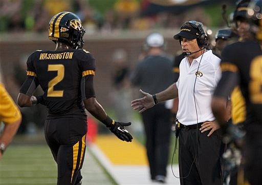 Missouri head coach Gary Pinkel congratulates L'Damian Washington after Washington scored a touchdown during the third quarter last Saturday against Murray State in Columbia.