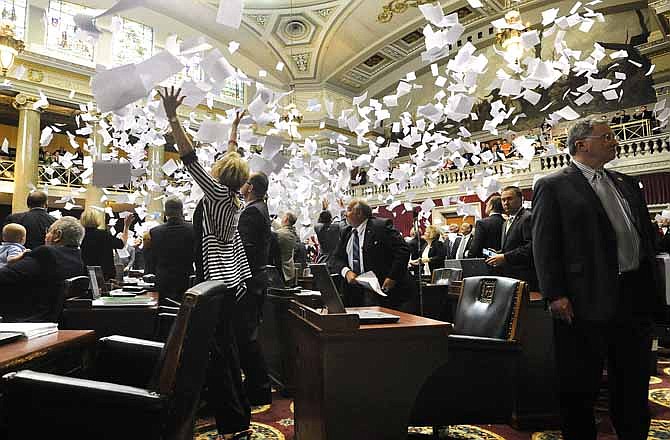 In this file photo, members of the Missouri House of Representatives toss their papers into the air in celebration as House Speaker Rep. Timothy Jones (R-Eureka) strikes the gavel to adjourn the final day of the regular 2013 legislative session in Jefferson City on May 17. Legislators will be back in town Wednesday for a veto session that could last two or three days.