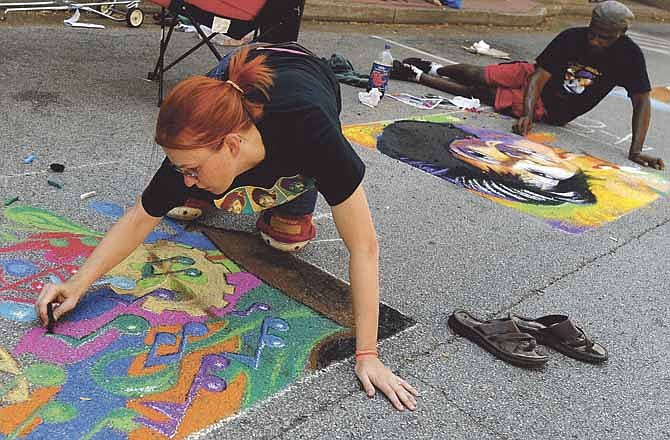 
Artists Jenny Neff, left, and Essex Garner work on their street chalk art pieces along Jefferson City's High Street while participating in the Capital Street Art Fair during the 22nd annual Capital JazzFest on Saturday.