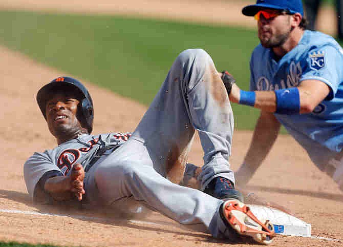 Detroit Tigers' Austin Jackson, left, looks to the umpire after being tagged out by Kansas City Royals third baseman Mike Moustakas, right, during the sixth inning of a baseball game at Kauffman Stadium in Kansas City, Mo., Sunday, Sept. 8, 2013.