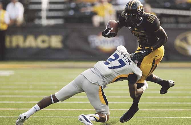 Missouri's Dorial Green-Beckham, right, is tackled by Toledo's Jordan Martin, left, during the third quarter of an NCAA college football game Saturday, Sept. 7, 2013, in Columbia, Mo. Missouri won the game 38-23.