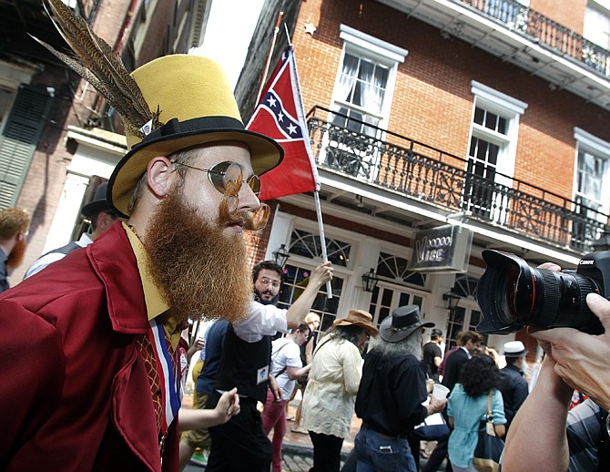 Jeffrey Moustache looks ahead as a photographer singles him out during a parade through the French Quarter kicking off the fourth annual Just For Men National Beard and Moustache Championships. 