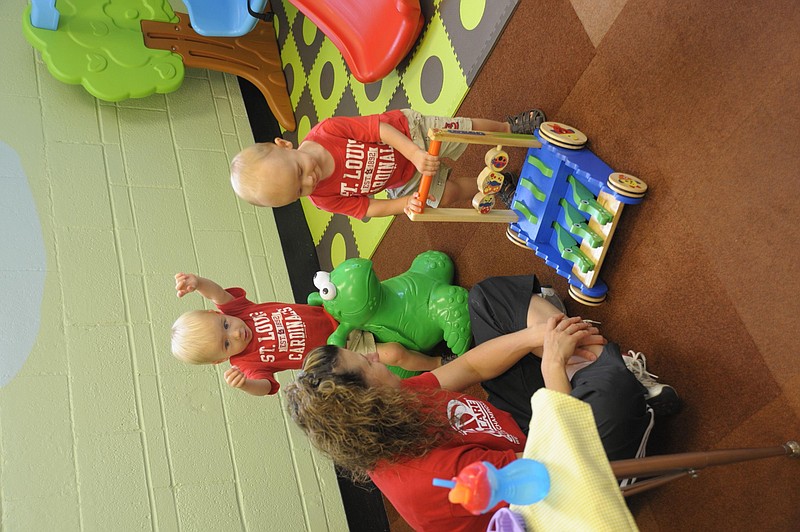 Twins Grayson and Adler Kautsch test out new educational toys at the Cole County R-1 Schools Parents As Teachers Play Center, which held an open house Friday for the grant-funded expansion. Democrat photo/Michelle Brooks