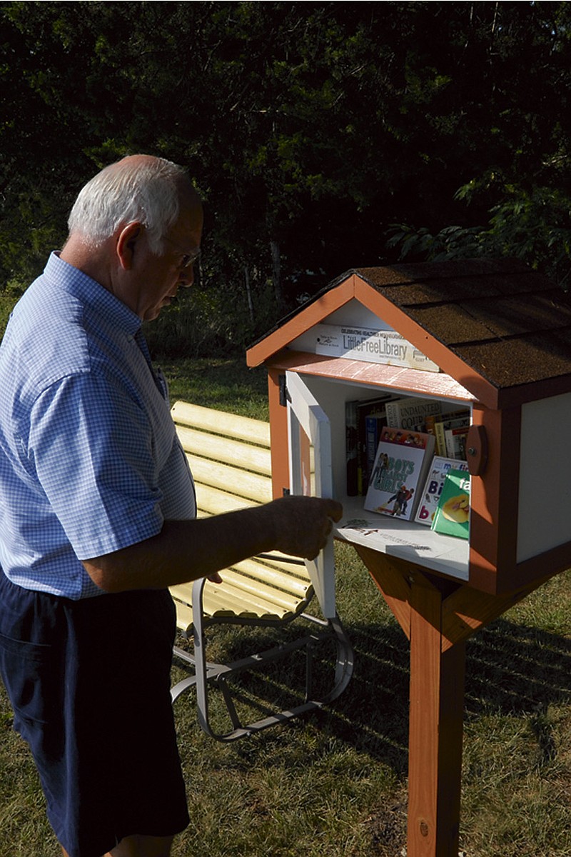 A Little Free Library will open in Russellville Thursday, Sept. 5, 2013, joining more than 9,000 sites in 50 states and more than 30 nations. Eugene and Gladys Moll have stocked the outdoor kiosk and hope to see their neighbors borrow and drop off books in the future. (Democrat photo/Michelle Brooks)