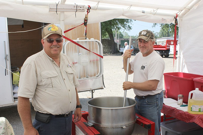 Brothers Ron and Larry Cox of Fulton stir up a batch of Larry's Country Kettle Korn during the Mokane Fair Sept. 7. The brothers often donate proceeds to various charitble causes.