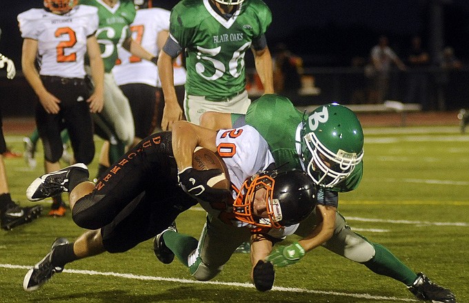 Matt Glover of Blair Oaks drags down Devon Dowler of Owensville after a screen pass during last Friday night's game at the Falcon Athletic Complex.