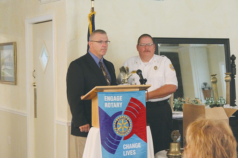 Auxvasse Police Chief Kevin Suedmeyer, left, accepts the 2013 G.W. Law Award from Deputy Chief Charlie Anderson at the Fulton Rotary Club's meeting and banquet Wednesday, held in the Fulton Country Club. Suedmeyer began his career in 1999 with the Columbia Police Department before joining Auxvasse in 2002.