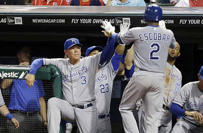 Kansas City Royals manager Ned Yost (3) congratulates Alcides Escobar (2) after Escobar hit a solo home run off Cleveland Indians starting pitcher Zach McAllister in the fifth inning of a baseball game, Tuesday, Sept. 10, 2013, in Cleveland.