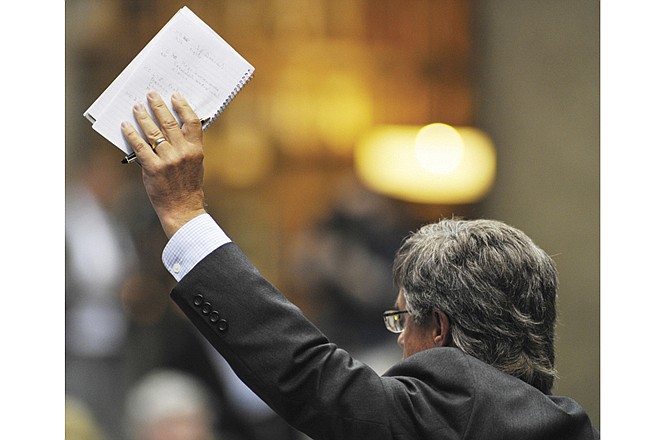 Rep. Jeffery Justus, R-Branson, raises his hand to speak during Wednesday's veto session.
