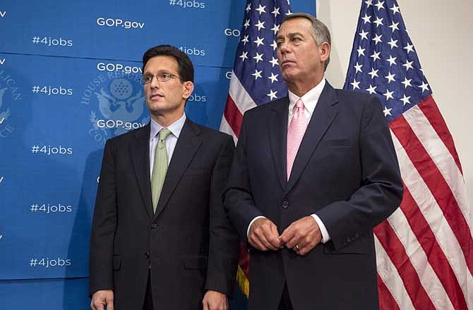 House Majority Leader Eric Cantor of Va., left, and House Speaker John Boehner of Ohio, right, the leaders of the Republican-controlled House of Representatives, stand together at a news conference following a GOP caucus on Capitol Hill in Washington, Tuesday, Sept. 10, 2013. Eager to avoid blame for a possible government shutdown next month, Boehner and Cantor have been confounded by tea party conservatives who want to use the fast-approaching deadlines to derail the implementation of President Barack Obama's health care law. 