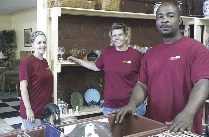 Serving customers through resale and an eBay drop-off location in Jefferson City at Carder's Finds are, employee Katrina Lewis, and owners Cari Ellis and Derek Moore.