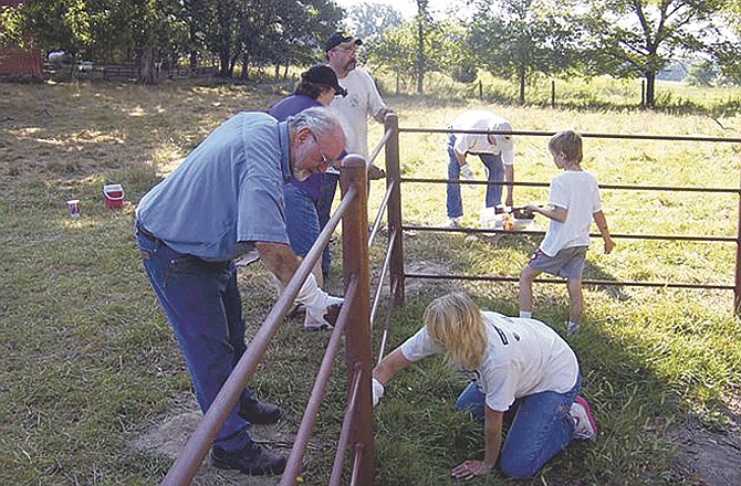 Elijah Gates Camp Commander Noel Crowson, front left, and others prime the fence to prepare it for painting. In addition to the Sons volunteers, the Daughters of Confederate Veterans helped with the project.