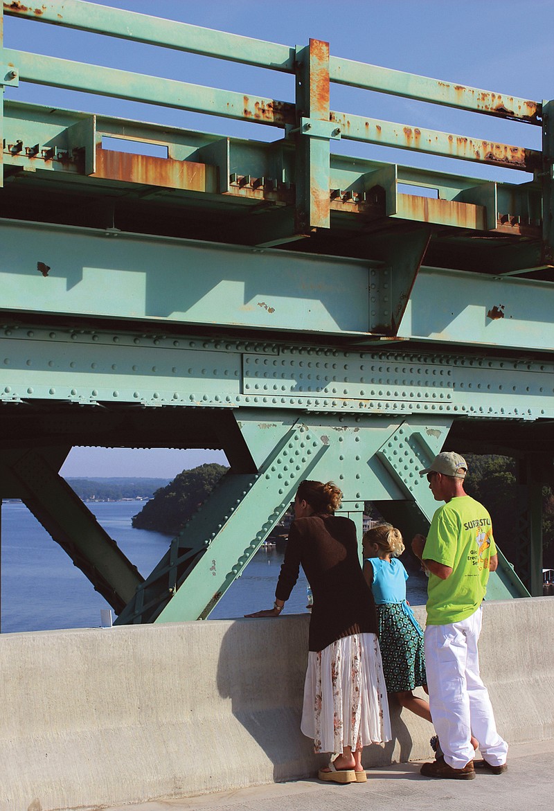 People look at the Lake of the Ozarks during a bridge walk to celebrate the opening of the new Hurricane Deck bridge which replaces the old rusting Missouri 5 bridge, background.