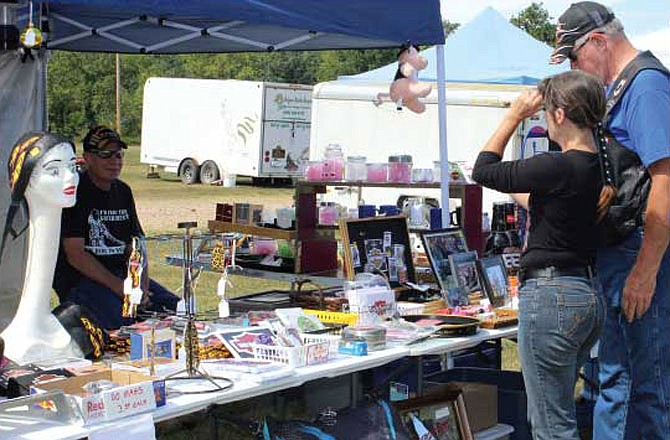 Above, visitors to the lake area check out a merchandise booth at the Dam Bait Shop & Campground, one of this year's new vendor villages for the 7th Annual Lake of the Ozarks Bikefest.
