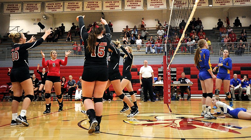 The Jefferson City Lady Jays celebrate after a point early in Monday night's match against the Fatima Lady Comets at Fleming Fieldhouse.