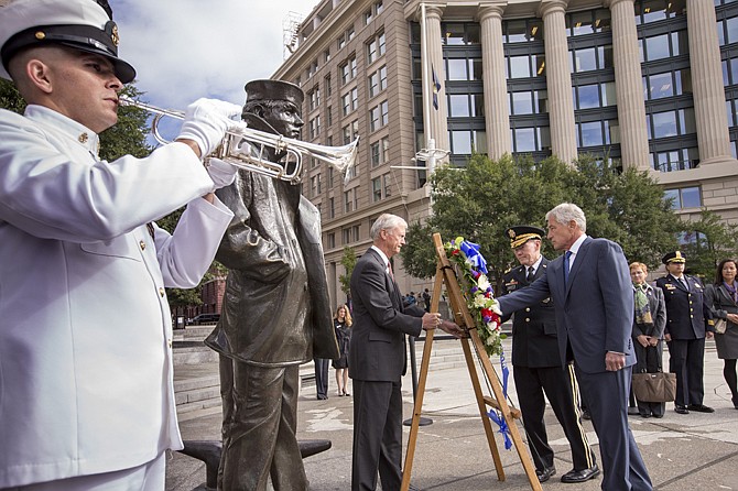 Defense Secretary Chuck Hagel, right, and Joint Chiefs Chairman Gen. Martin Dempsey, second from right, present a wreath Tuesday at the Navy Memorial in Washington to remember the victims of Monday's deadly shooting at the Washington Navy Yard.