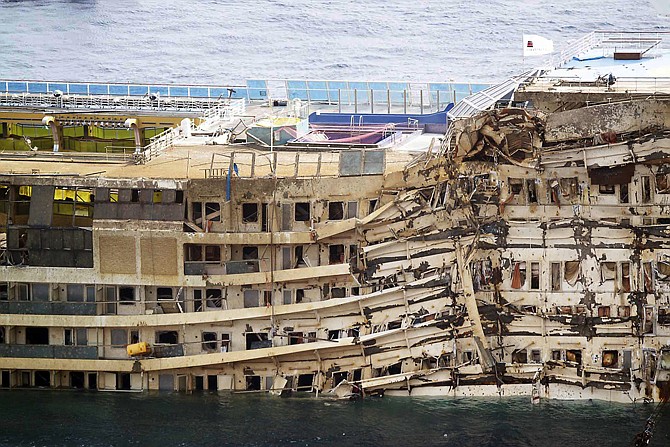The crippled Costa Concordia cruise ship was pulled completely upright early Tuesday after a complicated, 19-hour operation to wrench it from its side where it capsized last year off Tuscany.