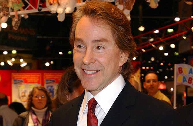 In this Feb 16, 2003 file photo, Ty Warner, Beanie Baby creator arrives at the Toy Fair to sign "Decade," the10th anniversary baby bear in New York.