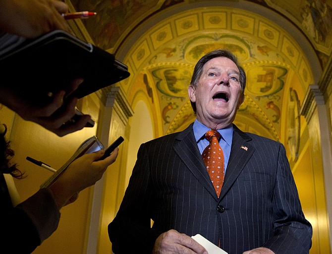 Former House Majority Leader Tom DeLay talks to reporters Thursday as he leaves a lunch meeting on Capitol Hill. A Texas appeals court tossed the criminal conviction of DeLay on Thursday, saying there was insufficient evidence for a jury in 2010 to have found him guilty of illegally funneling money to Republican candidates. 