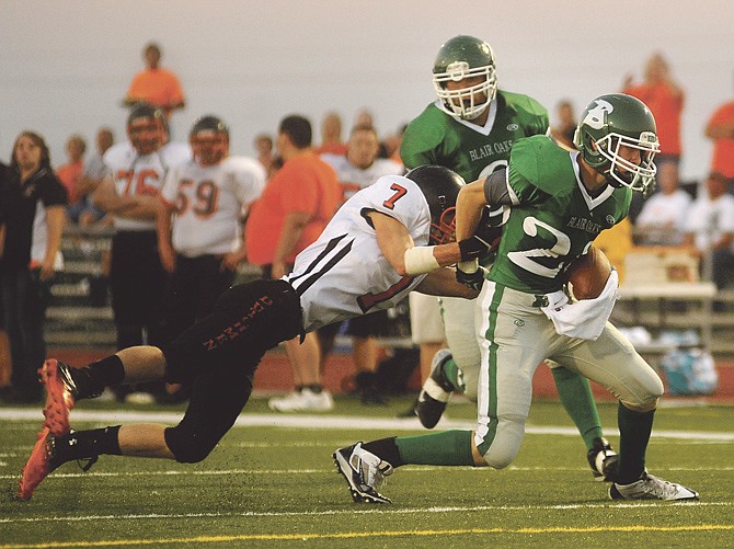 Haydn Lock of Blair Oaks breaks an attempted tackle on his way to a touchdown during a game earlier this month against Owensville in Wardsville, Mo..