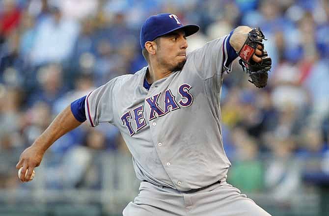 Texas Rangers pitcher Matt Garza throws to a batter in the first inning of a baseball game against the Kansas City Royals at Kauffman Stadium in Kansas City, Mo., Saturday, Sept. 21, 2013.