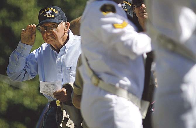Veteran Harold Shockley, who served as one of the original Navy Seabees during World War II, salutes as members of the Jefferson City Navy Sea Cadets post the colors at the conclusion of Saturday's Navy Seabee memorial dedication at the Jefferson City National Cemetery.