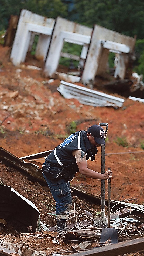 A rescue worker searches for bodies at the site of a landslide in the village of La Pintada, Mexico, on Sunday.