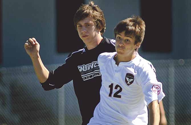 
Colton Acock of Jefferson City battles Evan Curran of Quincy for control of the ball Saturday afternoon.