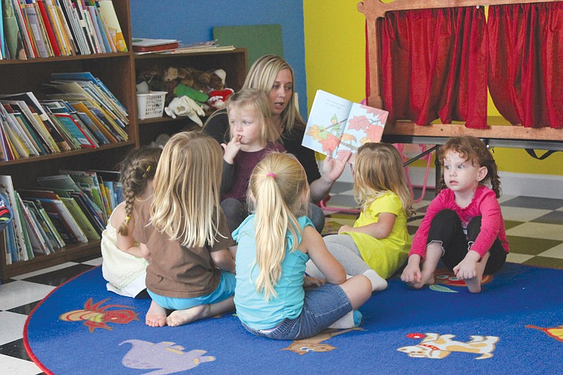 Nancy Neel reads to a pre-bedtime story to a group of children Monday at Tina Rich's new Fulton daycare center, Creative Minds. The center opened last week on Glover Street off of North Bluff Street, and caters to preschool children from infancy to 5 years old.