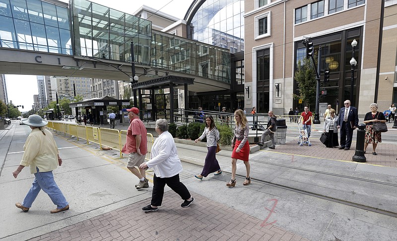 People walk across the street Tuesday in front of the City Creek shopping center in Salt Lake City, Utah. Jack Harry Stiles, a Utah man accused of plotting a deadly attack on a outdoor shopping center in the heart of Salt Lake City this week told investigators he planned to "just randomly shoot and kill people."
