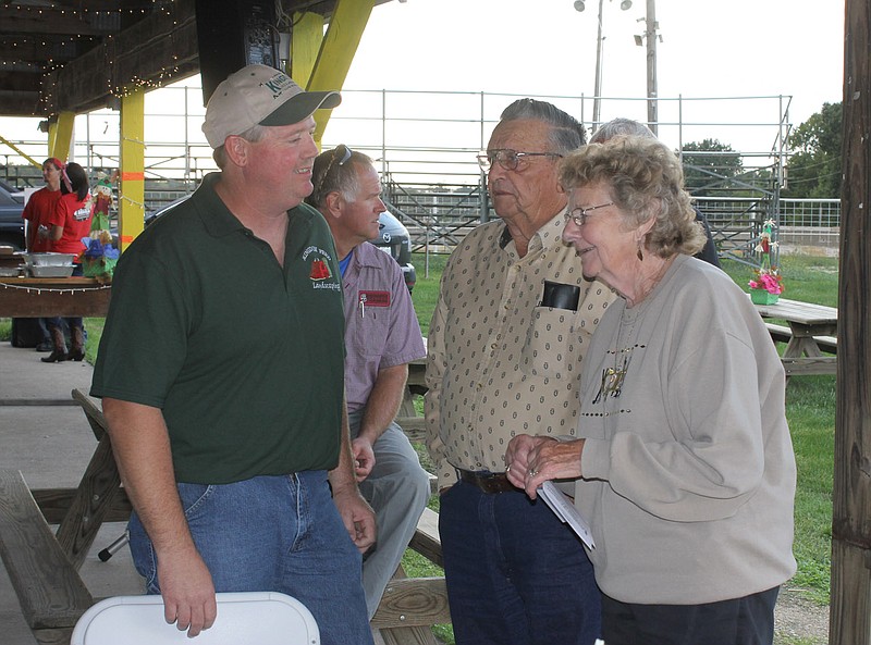 Kingdom Feed owner Darrel Wilmsmeyer visits with neighbors (and customers) Leroy and Tilly Garriott at the Kingdom of Callaway Chamber of Commerce Town and Country Dinner Tuesday night. Kingdom Feed was honored by the chamber as the Ag Business of the Year.