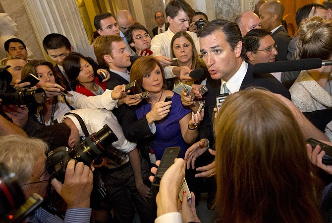 Sen. Ted Cruz, R-Texas, right, speaks to the media Wednesday after leaving a marathon speech on the Senate floor on Capitol Hill in Washington.