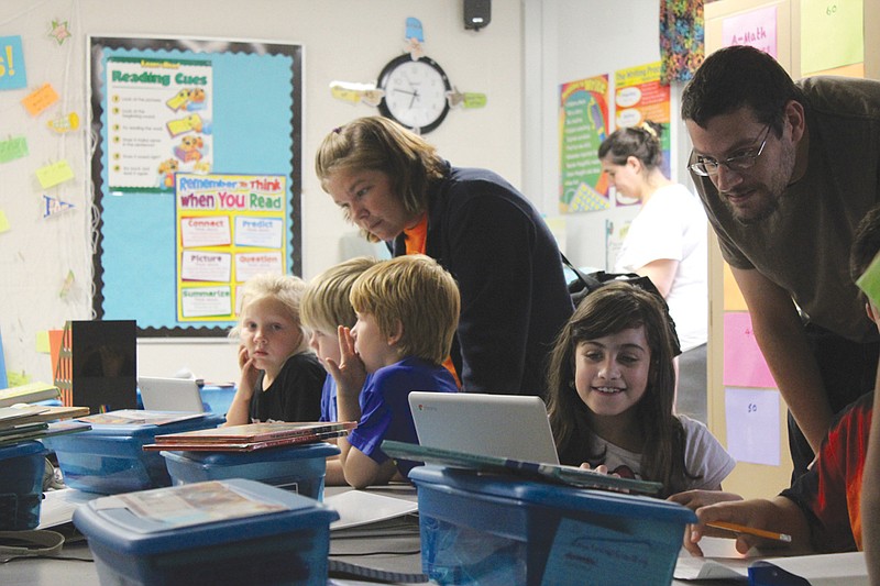 Students in Brandi Hassien's third-grade class at Bush Elementary show their parents online tools they use in class as part of the Everyday Math program. Bush held Family Math Night Wednesday to help parents understand the new program used to teach their children math with an emphasis on real-world applications.