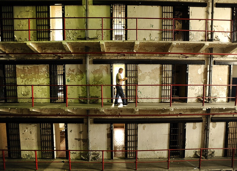 Greg Kepner of Ottumwa, Iowa, walks past housing unit one's empty cells while participating in a tour at the Missouri State Penitentiary.