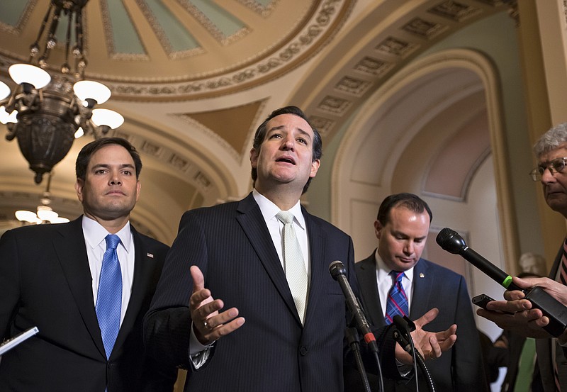 Sen. Ted Cruz, R-Texas, center, accompanied by Sen. Marco Rubio, R-Fla., left, and Sen. Mike Lee, R-Utah, right, express their frustration Friday after the Senate passed a bill to fund the government, but stripped it of the defund "Obamacare" language as crafted by House Republicans, on Capitol Hill in Washington. The Republican-controlled House and the Democrat-controlled Senate are at an impasse as Congress continues to struggle over how to prevent a possible shutdown of the federal government when it runs out of money in three days.