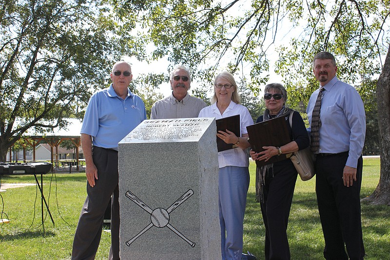 The city of Fulton and Fulton State Hospital came together to honor Robert J. Seaman, the former Business Office Manager who built Seaman Field and a slew of other hospital buildings, with the dedication of a granite memorial at the ballfield Friday. From left: Mayor LeRoy Benton, Robert Seaman (Seaman's son) and his wife Carol, Beverly Smart (Seaman's daughter) and Hospital Management Assistant Jeff Stone.