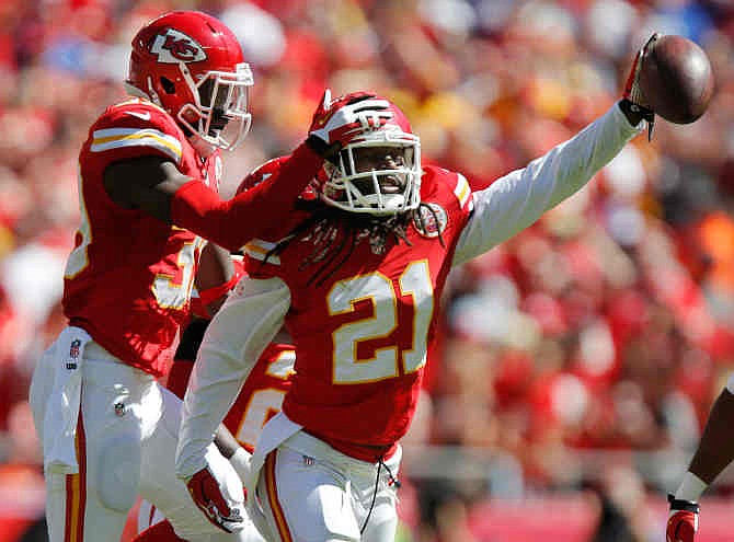 Kansas City Chiefs cornerback Dunta Robinson (21) celebrates a fumble recovery with defensive back Husain Abdullah (39) during the first half of an NFL football game against the New York Giants at Arrowhead Stadium in Kansas City, Mo., Sunday, Sept. 29, 2013.