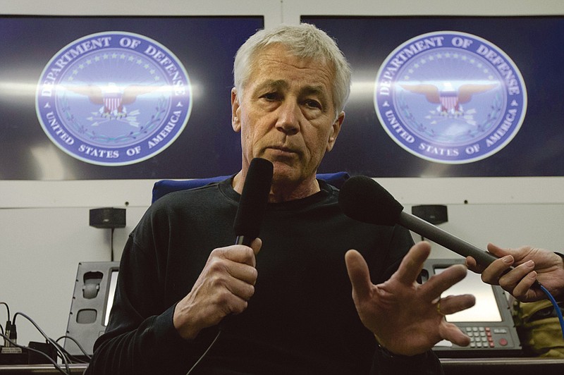 U.S. Defense Secretary Chuck Hagel speaks to the press on a U.S. military aircraft plane en route to Seoul, South Korea.