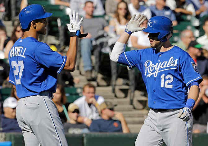 Kansas City Royals' Brett Hayes, right, celebrates with Justin Maxwell after Hayes' two-run home run against the Chicago White Sox during the seventh inning of an MLB American League baseball game in Chicago, Sunday, Sept. 29, 2013. 