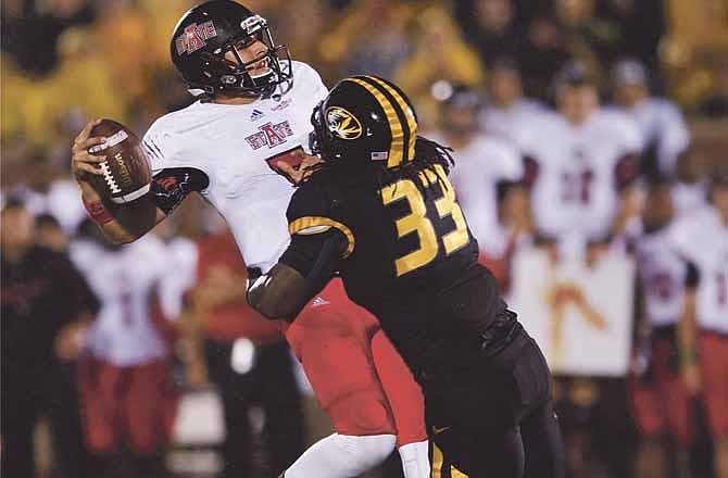 Missouri's Markus Golden, right, hits Arkansas State quarterback Adam Kennedy as he throws in the final seconds of the first half of an NCAA college football game Saturday, Sept. 28, 2013, in Columbia, Mo. (AP Photo/L.G. Patterson)