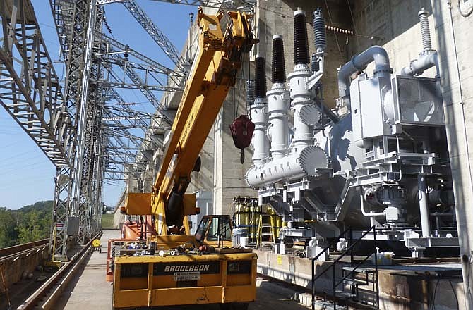 The huge light gray object at the base of Bagnell Dam is a gas-powered transformer. The transformers, which use a special gas called SF6, are only built at the Mitsubishi Plant in Tokyo, Japan.