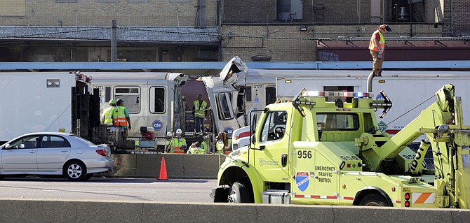 Authorities inspect the wreckage of two Chicago Transit Authority trains that crashed Monday in Forest Park, Ill. 