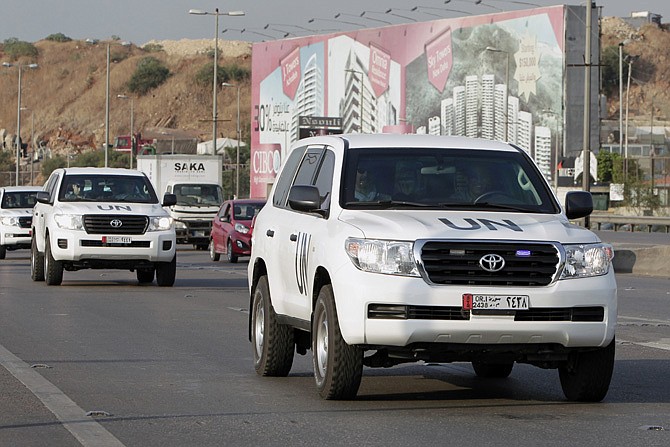 The convoy of a U.N. team of weapons inspectors, who concluded its almost week-long mission in Syria, arrive Monday at Rafik Hariri international airport in Beirut, Lebanon. The inquiry determined that the nerve agent sarin was used in the Aug. 21 attack on a Damascus suburb in Syria, but it did not assess who was behind it. 