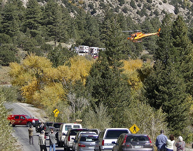 A Flight for Life Helicopter rises above backed up traffic Monday  in south-central Colorado. Roads were closed as emergency personnel worked to aid hikers trapped after a rock slide on the trail to Agnes Vaille Falls.