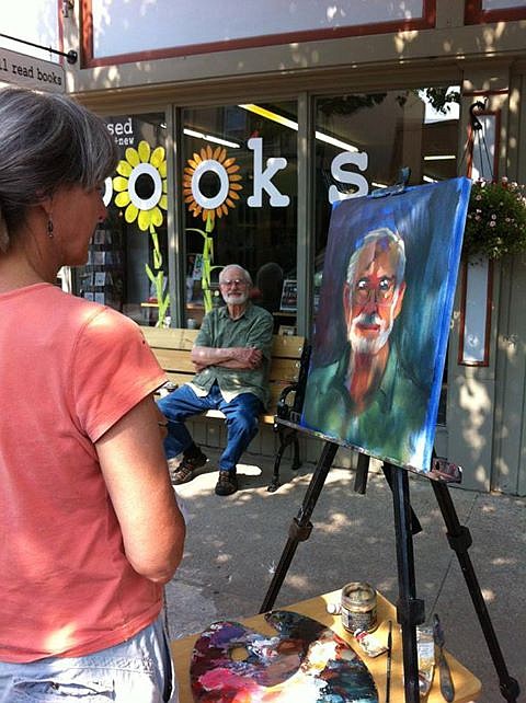 Fulton artist Jane Mudd paints a portrait of Gale Fuller in front of Well Read Books in downtown Fulton as part of a series called Reading Faces. 