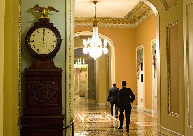 The Ohio Clock outside the Senate Chamber on Capitol Hill shows the time of 12:01 a.m. on Tuesday, Oct. 1, 2013 in Washington. Congress was unable to reach a midnight deadline to keep the government funded, triggering the first government shutdown in more than 17 years. 