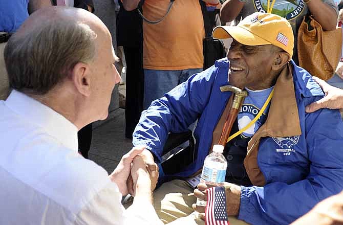 Rep. Louie Gohmert, R-Texas, left, shakes hands with 97-year-old Army World War II veteran Jesse Cook as he arrives to visit the World War II Memorial in Washington, Wednesday, Oct. 2, 2013. Cook came to Washington on an honor flight from Kansas City, Mo. It was an act of civil disobedience that marked the fact some barriers nor a government shutdown would keep a group of World War II veterans from visiting the monument erected in their honor. 