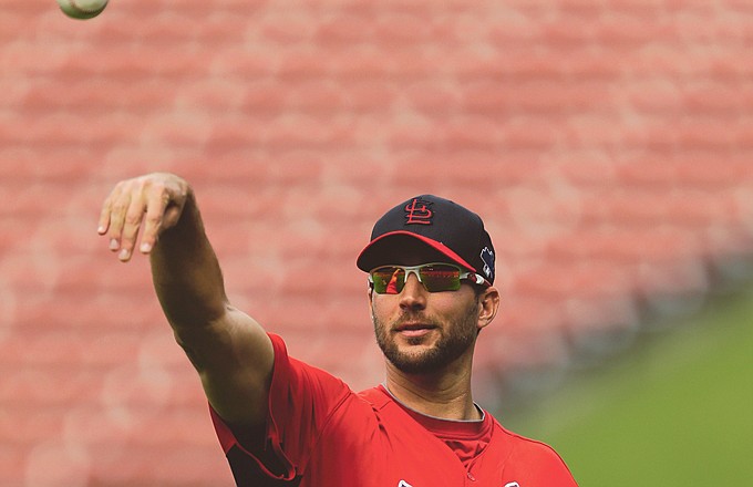 Cardinals starting pitcher Adam Wainwright tosses a ball during a workout Wednesday at Busch Stadium.