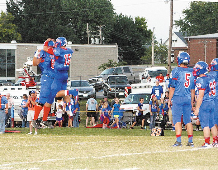 As their teammates look on, California quarterback Jaden Barr (15) chest bumps Alexx Lewis (69) after his introduction in the starting lineup of the California Pintos at Friday's Homecoming game at Riley Field. The Pintos tacked on another win to their unblemished record as they defeated the Southern Boone Eagles 42-0. 